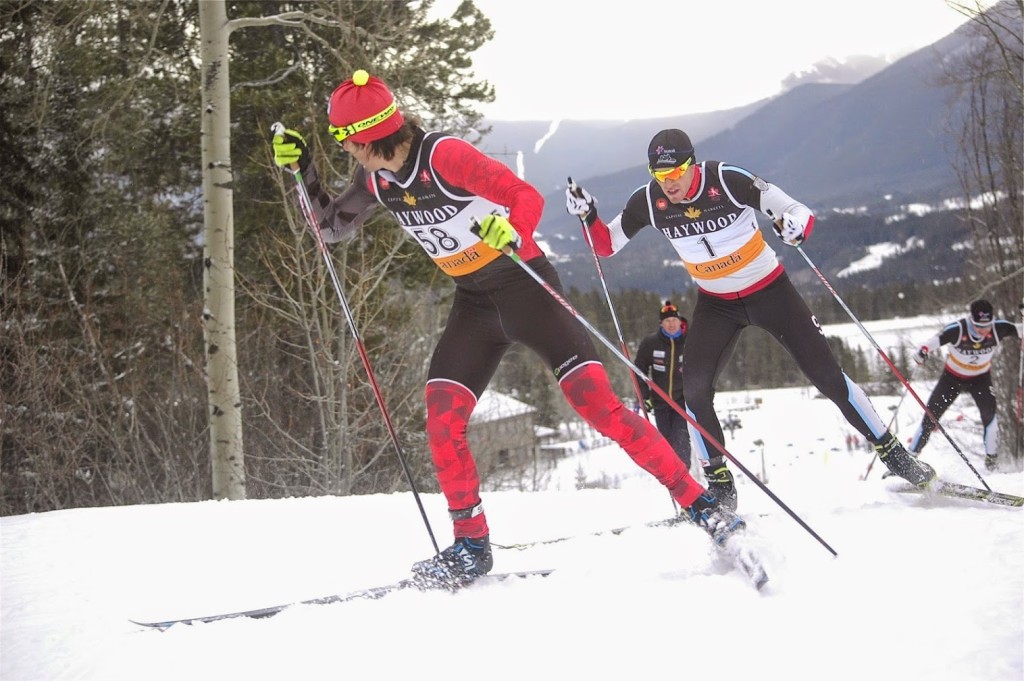 Biathlon Canada’s Scott Perras glances back at Michael Somppi (AWCA/NST-Dev.) while leading the men’s 20 k freestyle mass start on Sunday at the Canmore Nordic Centre in Canmore, Alberta. Photo: Angus Cockney